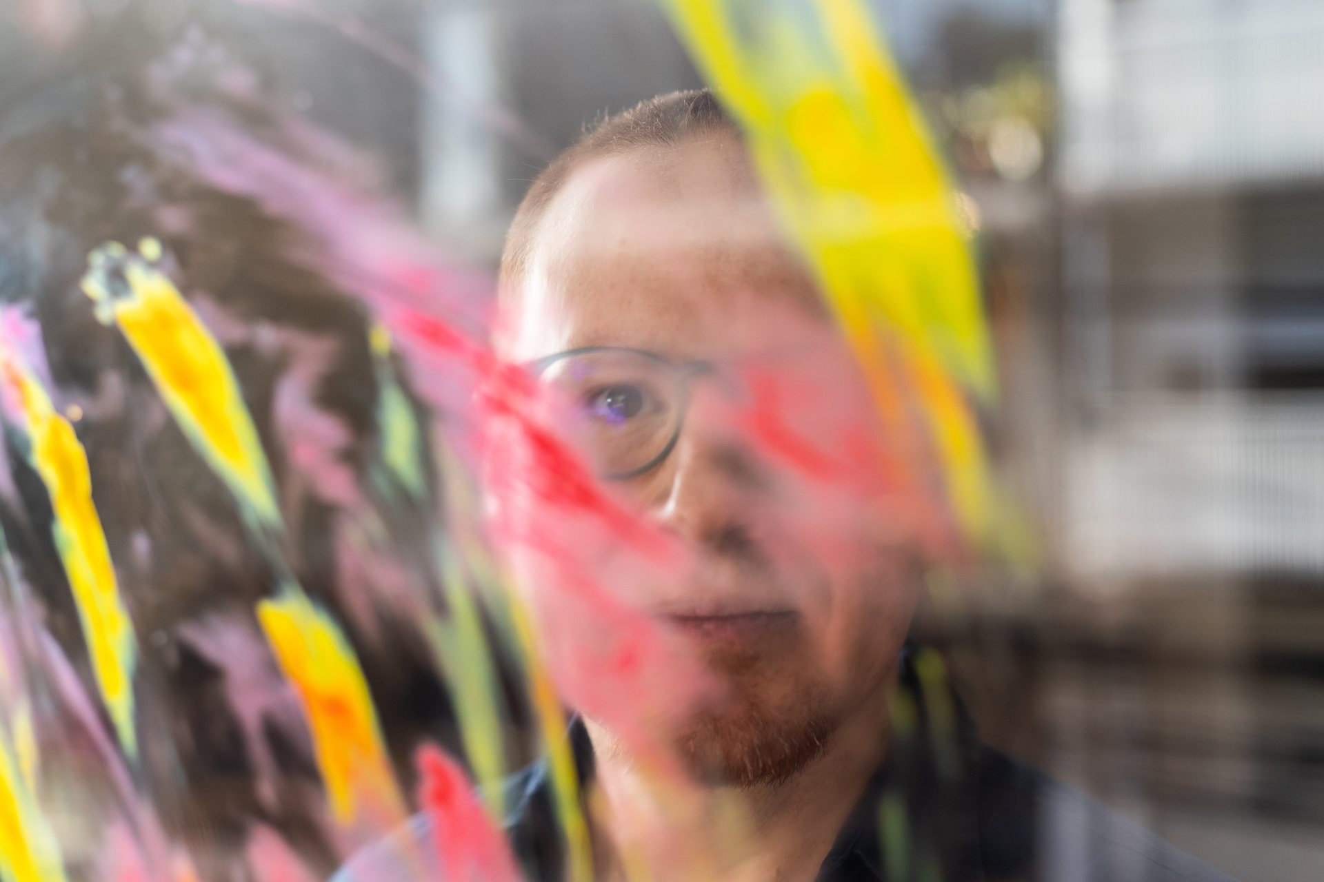 Javier Red behind painted glass, Life & Umbrella press photo by Mónica García